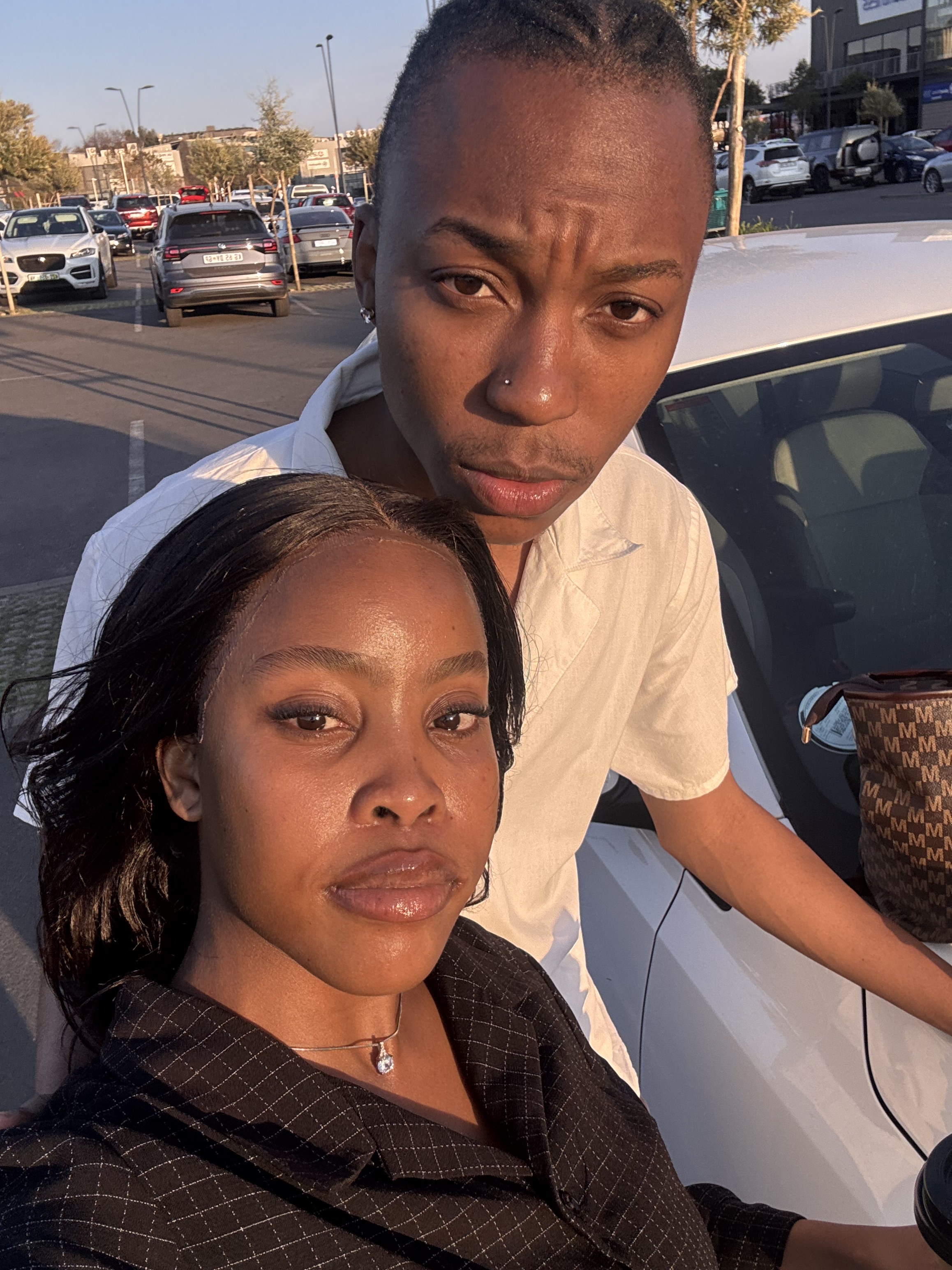 Golden-hour selfie together by the car